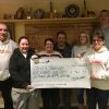 Gemma Youlden presents a cheque for £946 to Pete’s Dragons trustee and fellow Ottery St Mary resident Lesley Rowland. Also pictured (l-r) are Graham Rowland, Caroline and Dave Youlden, and Vicky and Rob Johns of Ottery Cricket Club.  
