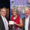 Jill Diprose receiving the cheque” from Ian Kingsbury accompanied by Bob Buckley of St. Michaels Lodge.