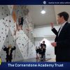 A teacher shows children using the climbing wall