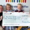Teachers and children holding a cheque for £2000