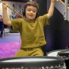 Little boy playing the drums in music studio