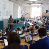 Children in uniform working with digital devices in the Year 6 lecture theatre