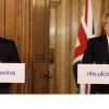 Boris Johnson looking unhappy at a press conference, accompanied by Rishi Sunak