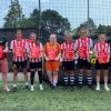 Exeter City A, women's winners of the Exeter City FC One Game One Community Group community diversity football tournament, with Simon Kitchen from ECFC OGOC group, left and Kevin Hack, tournament director, right.