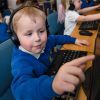 Year 1 BCPS student using touchscreen and headphones