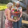 Kay receiving flowers from Mary Jane Campbell
