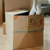 Moving boxes with child's scribble with feet hanging out