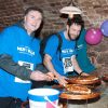 Men's Walk participants in Hospiscare t-shirts enjoy a pizza en route