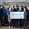 Group of people holding cheque