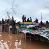 People sheltering on rooves of building in Buzi district Mozambique  
