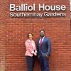 Two solicitors standing outside a sign for Balliol House in Exeter