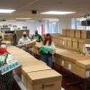 Staff from Exeter City Community Trust and volunteers pack up parcels at St James Park