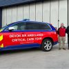 Picture of 4 men standing next to a Devon Air Ambulance critical care car