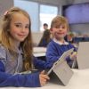 Two Westclyst Community Primary School pupils with their laptops in class