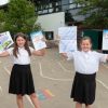 Pupils Lauren Bright (left) and Lilly Sparks (right) from Woodwater Academy with their highly commended and regional winning entries to HEE’s Step into the NHS competition