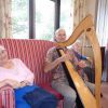 Residents at RMBI Home Cadogan Court relaxing to the music of harpist Luc Walpot.