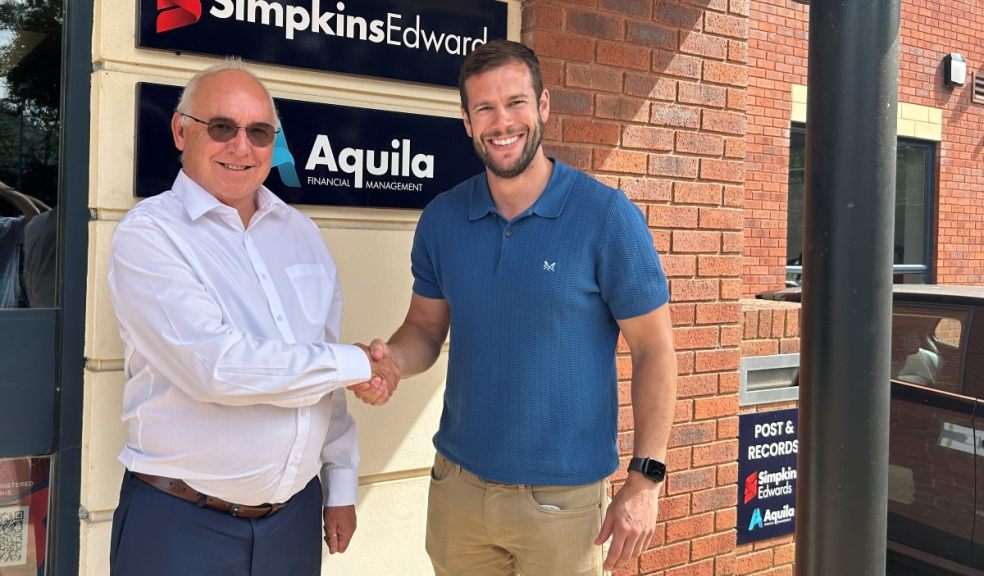 Two professionals shaking hands after business acquisition