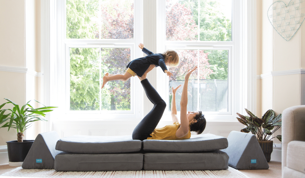 Founder of Sofee playing with her child on a Sofee play sofa.