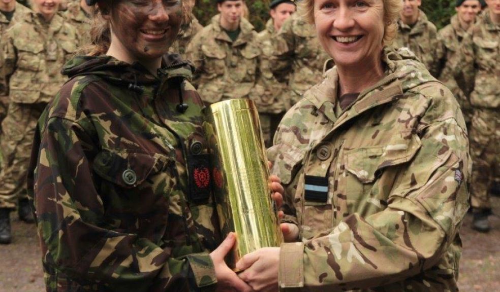 Exeter School's Senior RN Cadet Tilly Gilbert, in a welcome break from an exercise with the Royal Marines is awarded the Jack Sadler Trophy from Air Commodore Dawn McCafferty.