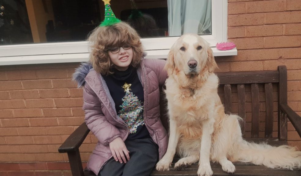 Chloe and Sapphire sit together outside on a wooden bench.