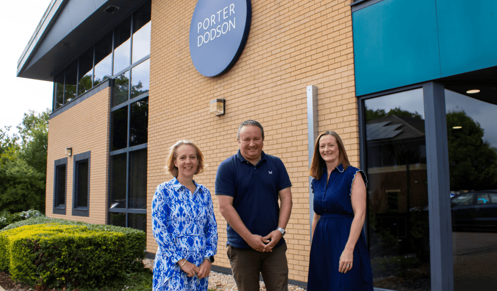 Three people stood outside a Porter Dodson office