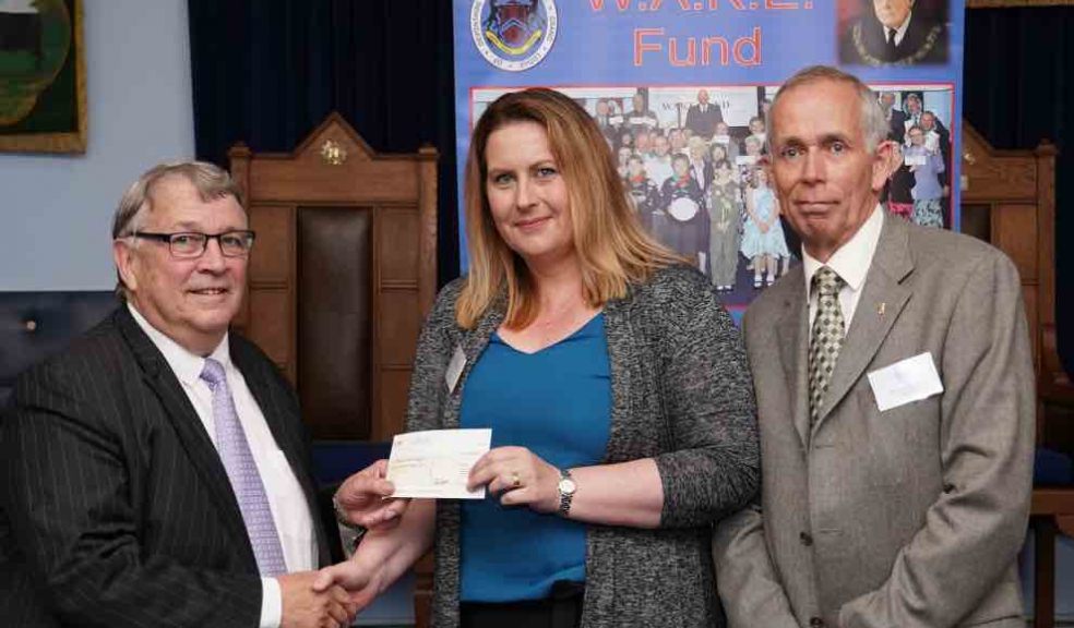 Pam Knight from Families for Children receiving the cheque from Ian Kingsbury accompanied by Mike Billington of Ashburton Lodge.
