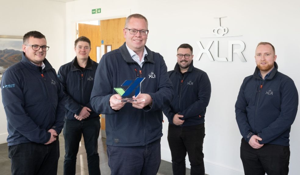 XLR Managing Director Chris Beer (centre holding award) with members of the XLR team.