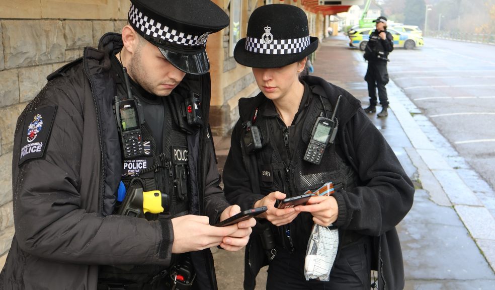 D&C Police Constables Nathan Smith and Helen Griggs update information on their PDAs at Torquay Railway Station joint operation
