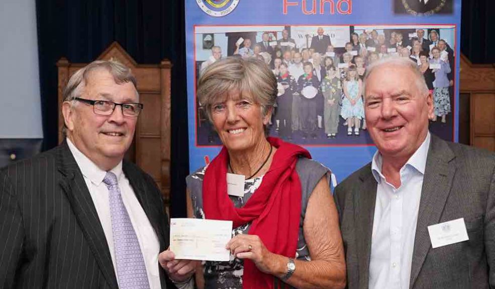 Jill Diprose receiving the cheque” from Ian Kingsbury accompanied by Bob Buckley of St. Michaels Lodge.