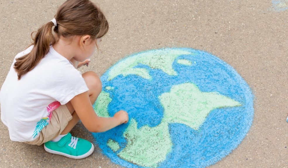 A girl draws a planet of the world with colored chalk on the asphalt. Children’s drawings, paintings and concepts. Education and art, be creative when you return to school. earth, Peace day. jpg  PICTURE: Getty Images/iStockphoto