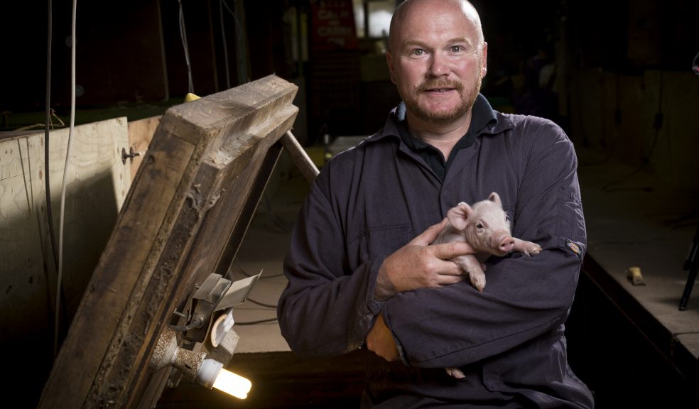 Andrew Freemantle of Kenniford Farm with one of the piglets