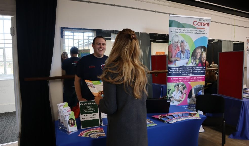 Andy Hood with a carer on the Devon Carers stand. Photo by Devon Carers.