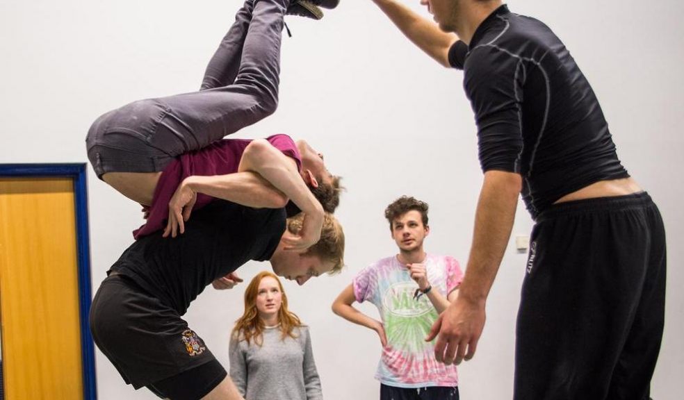 The cast practicing a physical theatre sequence in rehearsals.
