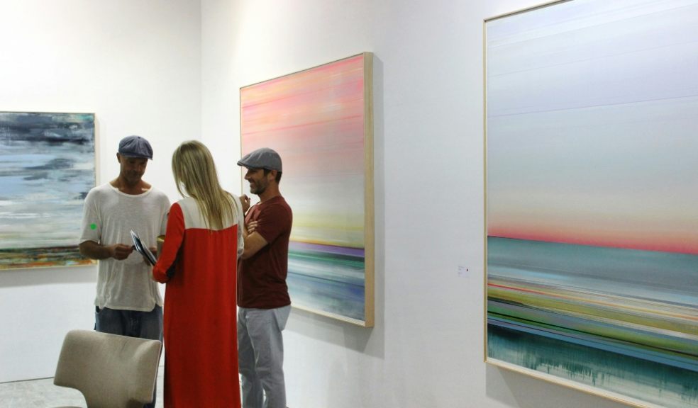 People talking at an art exhibition
