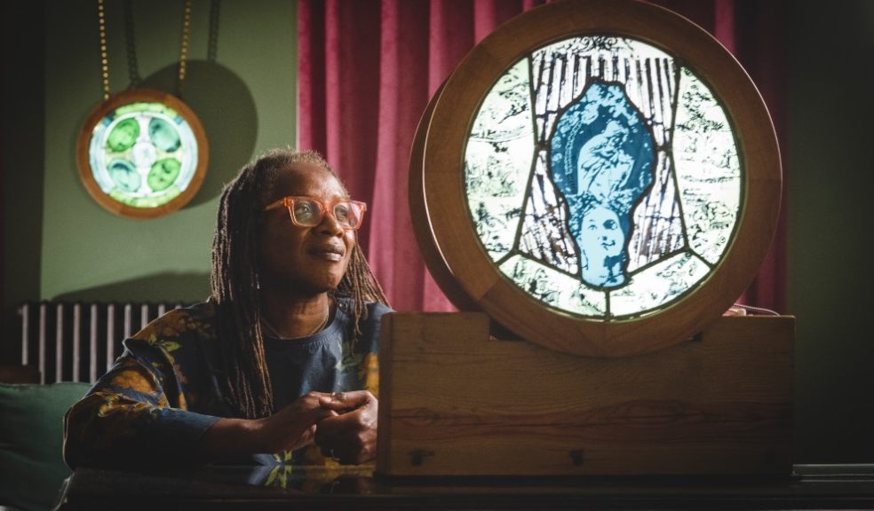 Artist Patricia Dixon, featuring two of the stained-glass roundels. Credit: Steve Haywood.