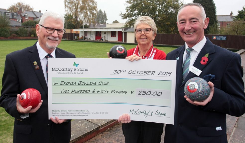 Exonia Bowls President Ted Powell & Ladies Secretary Maddy Bexon receive a cheque from McCarthy and Stone's Adrian Dyer, Sales Exec at Pinnoc Mews
