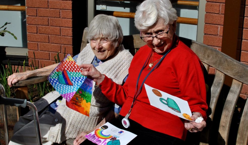 Delighted residents from Cadogan Court enjoying letters and cards from the pupils of Clyst Heath Primary School.