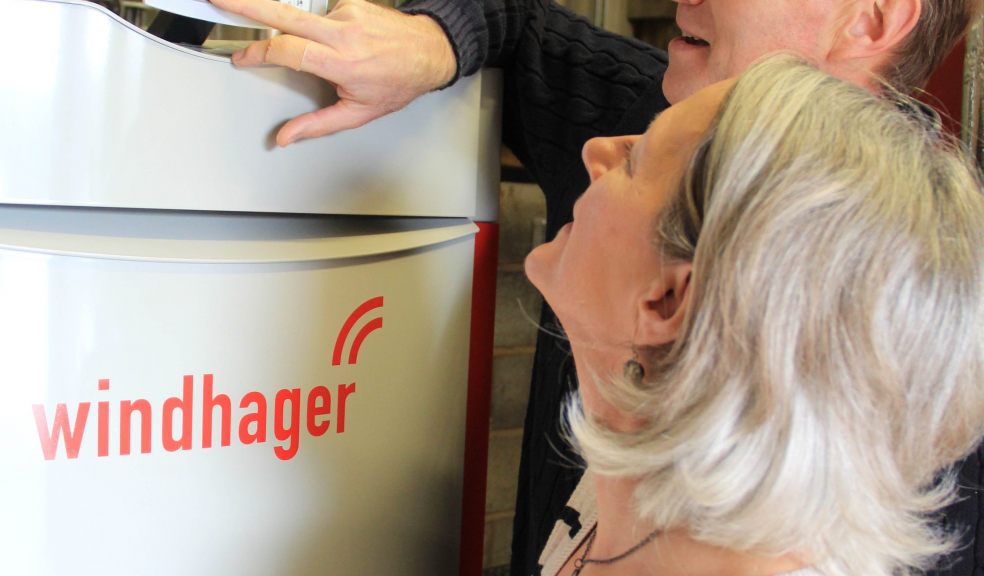 Charlie and Julia Hutchings operating Larkbeare Grange's new biomass boiler, which was installed by Exeter specialists SunGift Energy