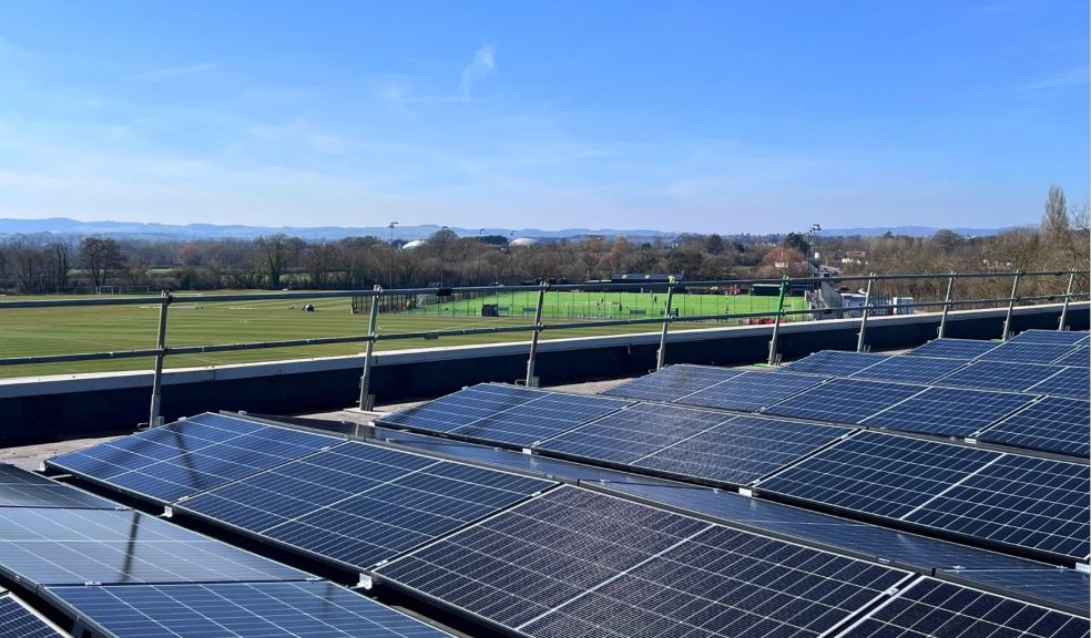 Roof mounted solar panels with football training in the background 
