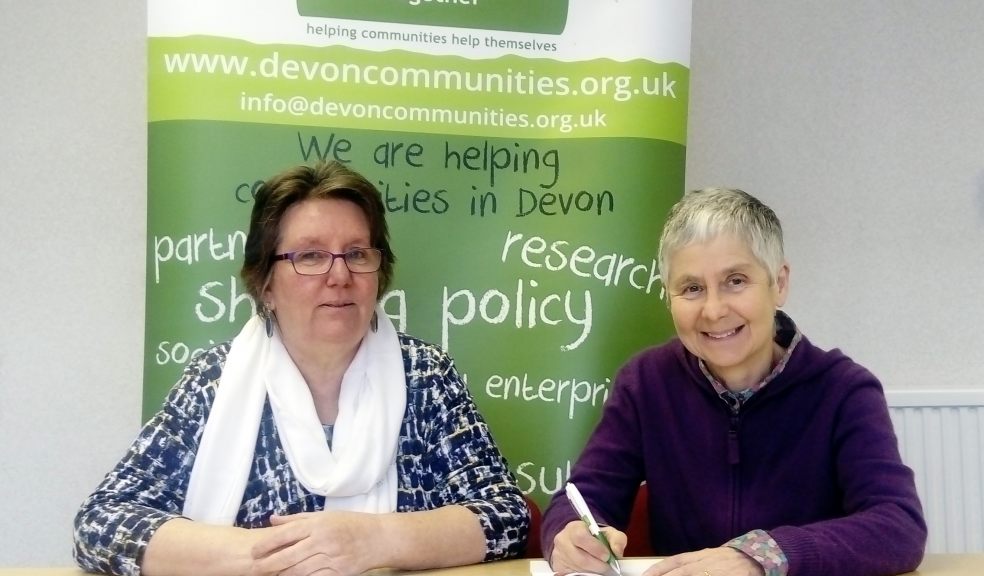 • Devon Communities Together’s Chief Executive Elaine Cook (l) and Chairman Teresa Butchers (r) sign the funding agreement for Constructing Futures Devon to launch the new company.