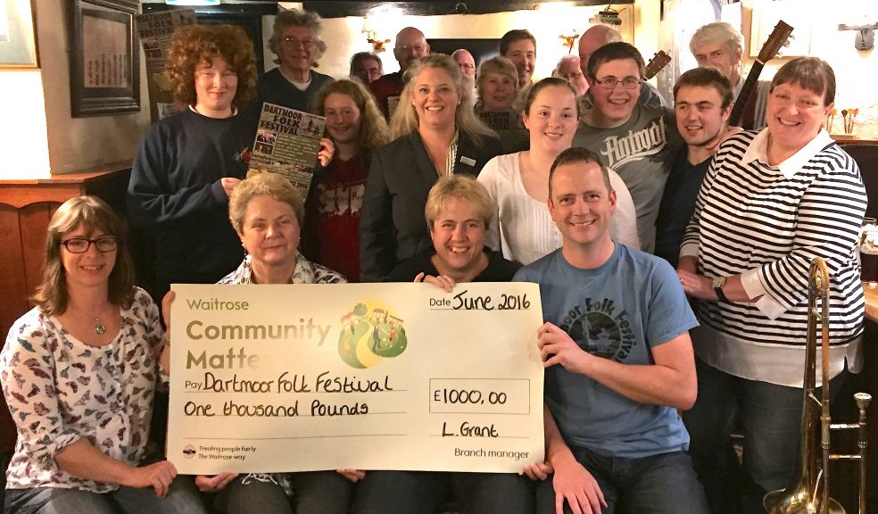 Members of the Dartmoor Folk Festival Association which received a cheque for £1,000 from Waitrose Okehampton from its Music Matters award scheme, pictured with the bumper cheque presented by Vickie Mills, the store's Community Matters partner, standing centre.