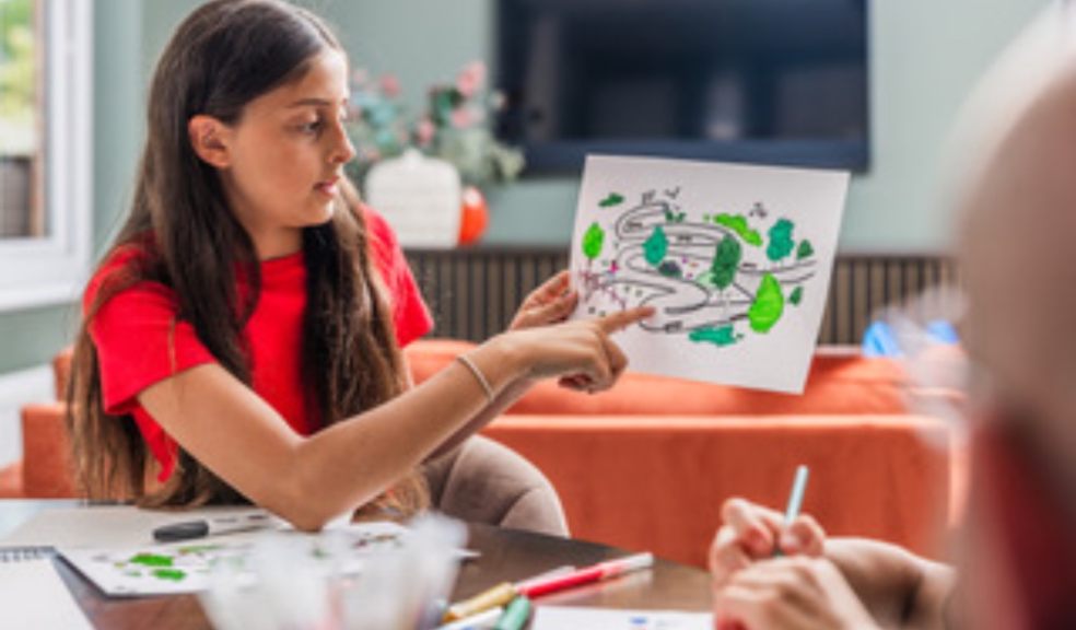 School girl pointing at picture drawn
