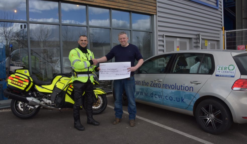 Devon Freewheelers trustee Russell Roe accepts the donation of £3,500 from Devon Contact Waste managing director Simon Almond