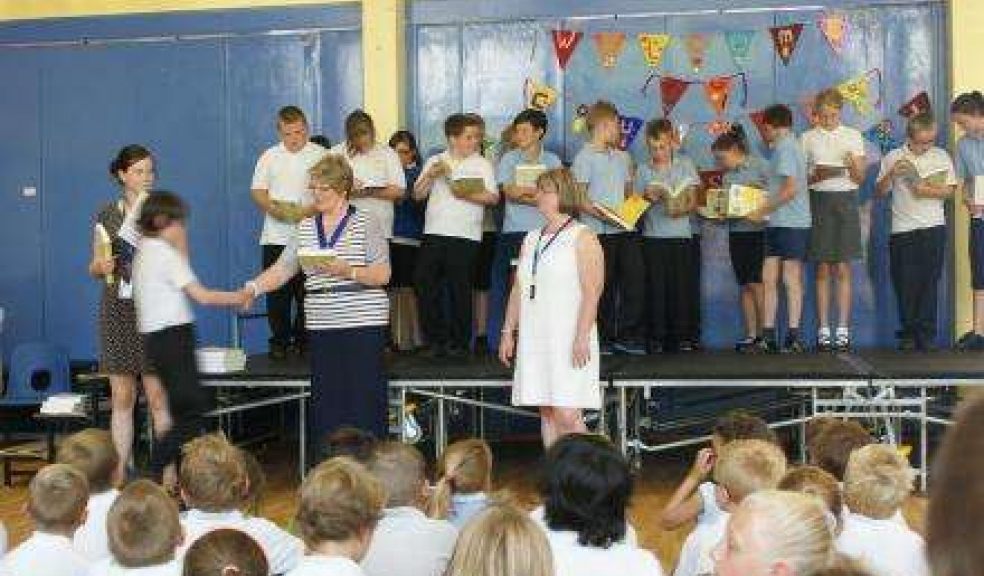 Immediate Past President Maureen de Vielle OBE presents the dictionaries to the pupils