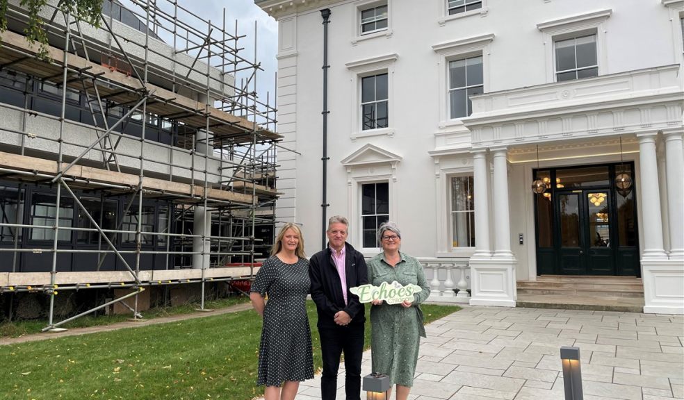 Three people standing outside Winslade House and Winslade Manor