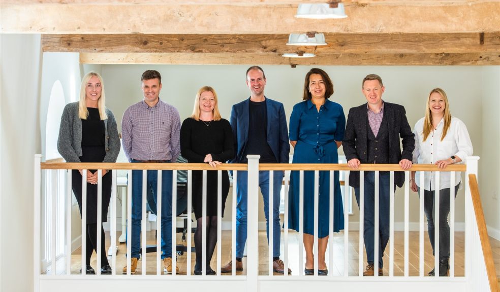 Exe Mortgages team People standing on a mezzanine