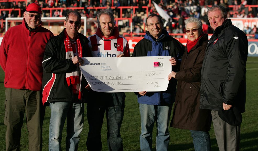 Members of Grecian Goal donate a cheque of £1,000 to Exeter City Chief Executive Julian Tagg (far right) during a game in the 2012/13 season (Photo: Keith Stone)
