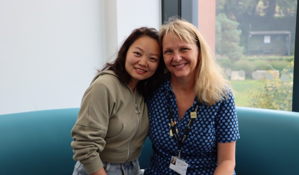 Jiao Jiao Wan (with her tutor) took GCSE Maths. Photo: Exeter College.