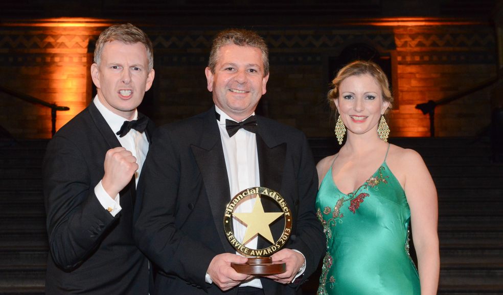 Exeter Family’s Head of Operations Alan Ord being presented with the award alongside comedian Patrick Kielty