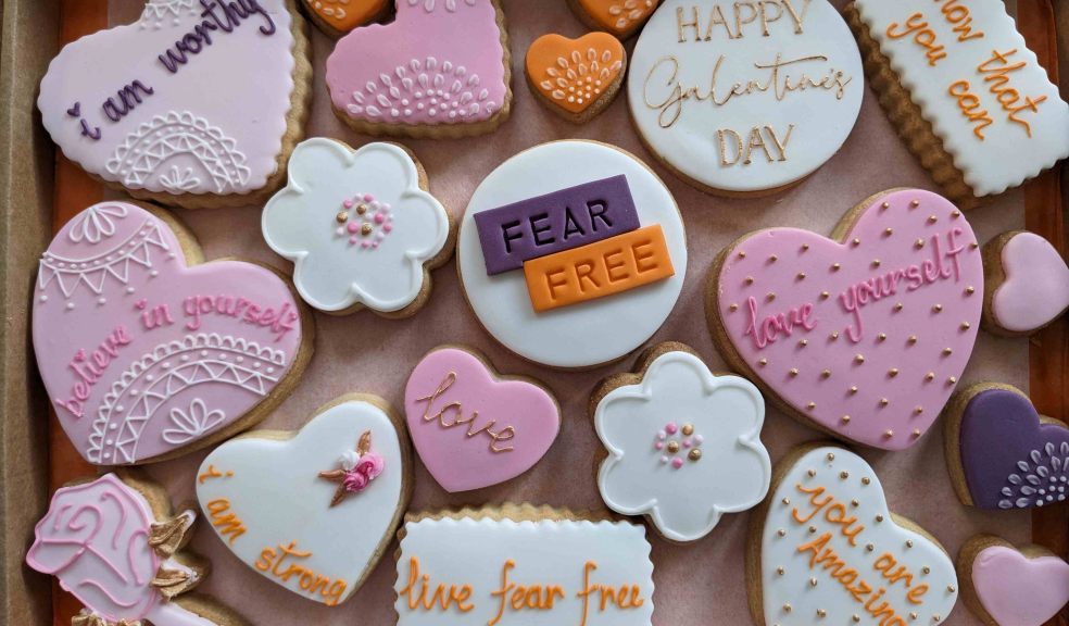 FearFree Love Yourself Bake Sale Purple, orange and white heart shaped and flower shaped cookies with empowering messages iced on